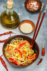 Soybean sprouts (Seedlings) salad with bell peppers, onions, garlic, spices and sesame seeds. Delicacy Oriental dish (Korean, Japanese, Chinese). Vegetarian snack. Selective focus
