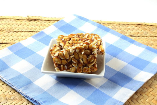 homemade traditional indian sweet chikki  or peanut candy bar made with rosated peanut and jaggery