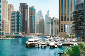 Blue canal with piers and yachts in the luxurious district of Dubai - Marina, UAE, Jun.2018