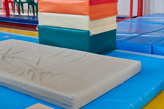 hall for gymnastics at school. multi-colored mats. doing sports. sports equipment. healthy lifestyle. sport competitions
