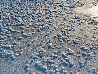 abstract texture of ice and snow on a frozen river in a highland sunset sun
