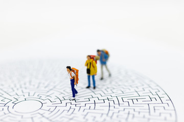 Miniature people: Tourists walk on the maze map. Image use for tourism campaign, spending money,...