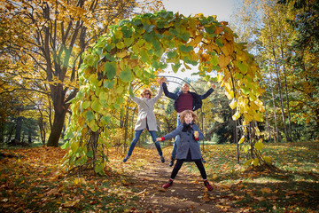 Cheerful family in the autumn park.