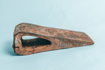 Old, rusty hammer on blue background. Retro tool.