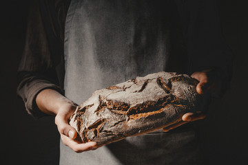 Baker or chef holding fresh made bread