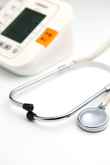 Stethoscope with Electronic Blood Pressure Monitor or Sphygmomanometer on the white background. Healthcare concept.