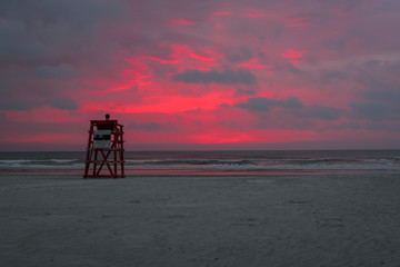 Person watching the sunrise on the beach