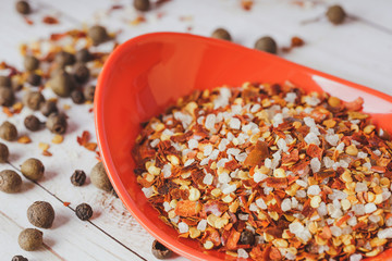 Gross natural sea salt mixed with dried red hot chili pepper, colorful seasoning close-up