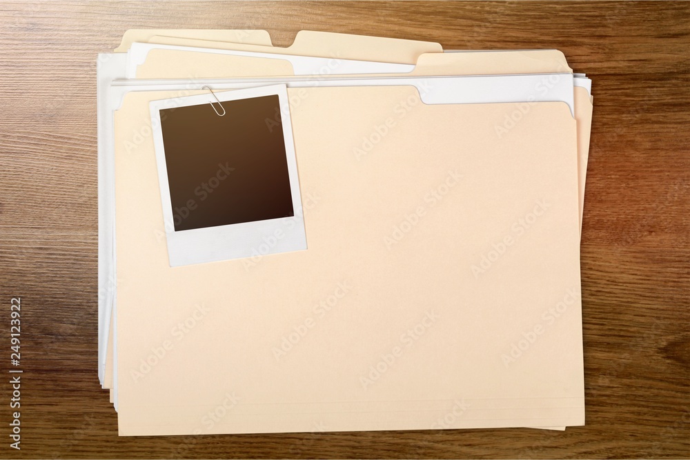 Sticker Blank photo on business folder on wooden table