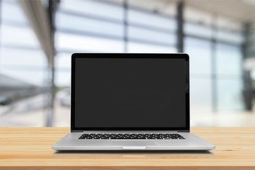 Laptop with blank screen on background