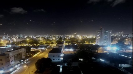 Time lapse of the night city with stars
