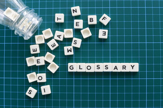 Glossary word made of square letter word on green background.