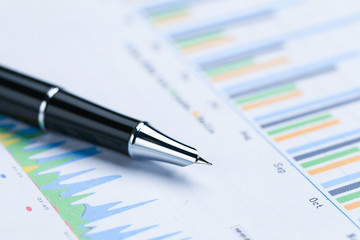 Naklejka na ściany i meble pen,glasses and calculator on Financial accounting stock market graphs analysis chart