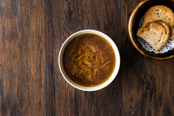 French Onion Soup with Bread on Dark Wooden Surface.