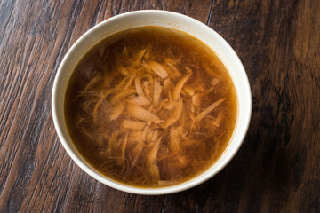 French Onion Soup with Bread on Dark Wooden Surface.