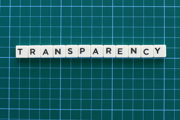 Transparency word made of square letter word on green background.