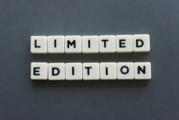 Limited edition word made of square letter word on grey background.