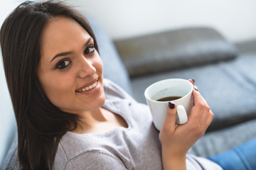 close up woman holding cup of coffee