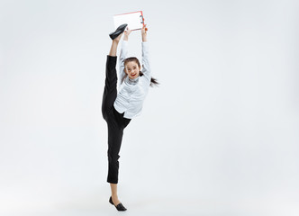 Happy businesswoman dancing and smiling in motion isolated on white studio background. Flexibility and grace in business. Human emotions concept. Office, success, professional, happiness, expression