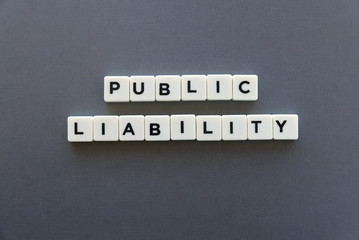 Public liability word made of square letter word on grey background.