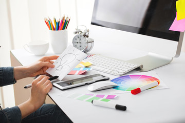 Young Handsome Graphic designer using graphics tablet to do his work at desk