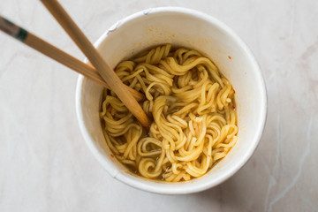 Instant Curry Flavored Ramen Noodles served with Chopsticks. in Plastic Cup
