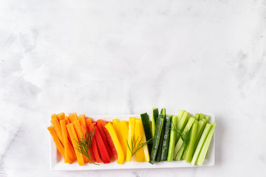 Colorful vegetable sticks in long plate. Top view.