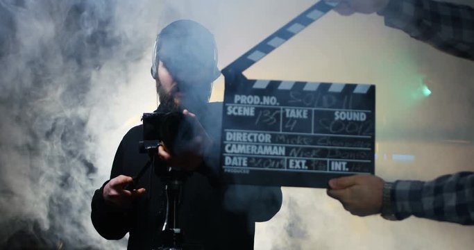 Film crew shooting take of scene in studio