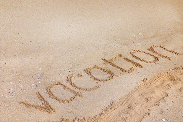 Sandy beach with written word Vacation on sunny day. Space for text