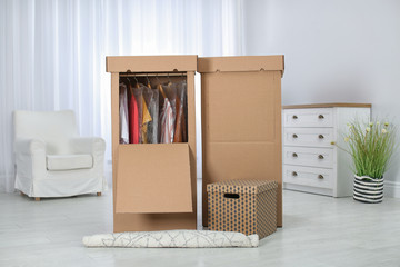 Wardrobe boxes with clothes in living room