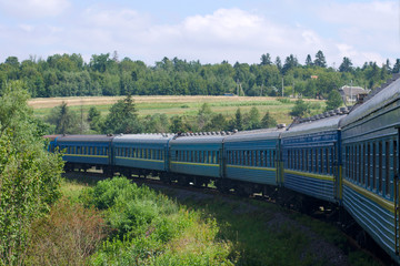 Fototapeta premium The long train moves to the mountains