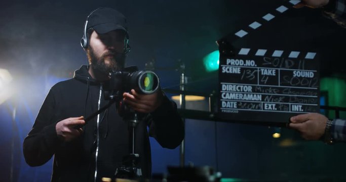 Film crew shooting take of scene in studio