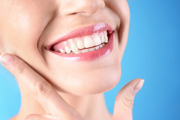Obraz premium Young woman with healthy teeth and beautiful smile on color background, closeup