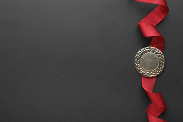 Gold medal on black background, top view with space for text. Symbol of victory - Powered by Adobe