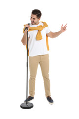 Fototapeta premium Young handsome man in casual clothes singing with microphone on white background