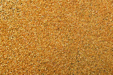 Texture of gold glitter as background, closeup