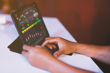 Sound engineer working at mixing panel in sound studio. Asian engineer
