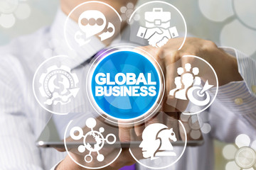 Man working on a tablet pc sees virtual screen of the future and touches the inscription: global business. International Business Entrepreneurship concept.