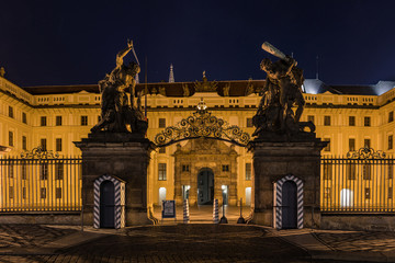Obraz premium Main Gate of Prague Castle with Statue of Battling Titans, Hradcanske Square at night, Prague, Czech Republic
