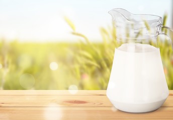 Glass jug of fresh milk isolated on white