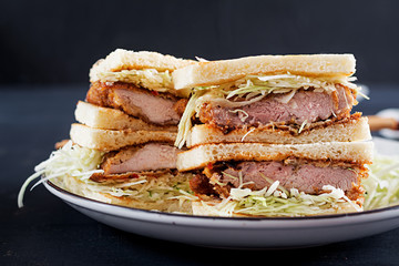 Katsu Sando - food trend japanese sandwich with breaded pork chop, cabbage and tonkatsu sauce. Japanese cuisine.
