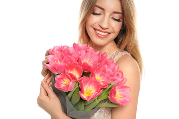 Portrait of smiling young girl with beautiful tulips on white background. International Women's Day