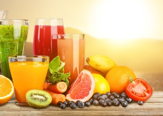 Tasty fruits  and juice with vitamins on background