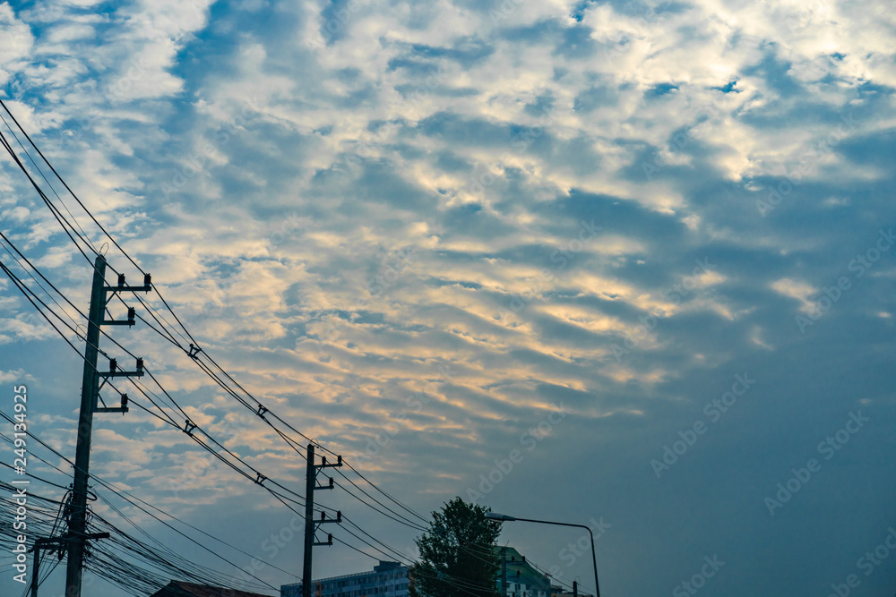 Wall mural cloud and gold light with electricity cable in the twilight time