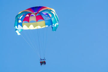 Sea and beach sport for tourists, parasailing in blue sky