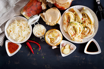 Fermented food. Vegetarian food concept. Cabbage kimchi, tomatoes marinated, sauerkraut sour glass...