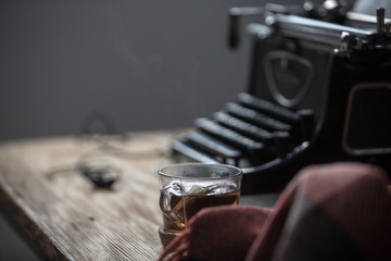 Workplace old school writer with tea and typewriter