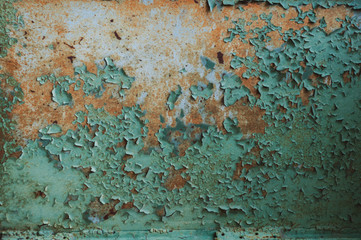 green cracked bare paint close up on a wooden horizontal surface