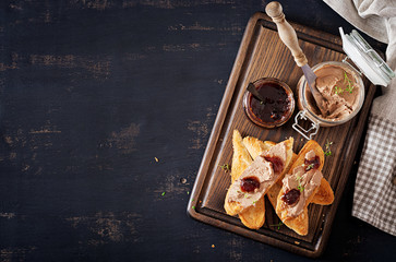 Chicken homemade liver paste or pate in glass jar with toasts and lingonberry jam with chili. Top...