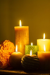 Six burning candles and roses, warm colors, feelings and memory, soft warm colors close up
